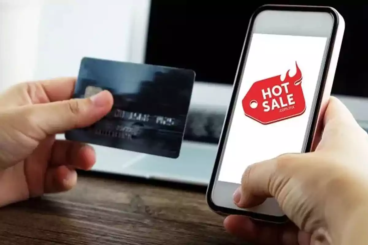 Person holding a credit card and a mobile phone displaying a Person holding a credit card and a mobile phone displaying a