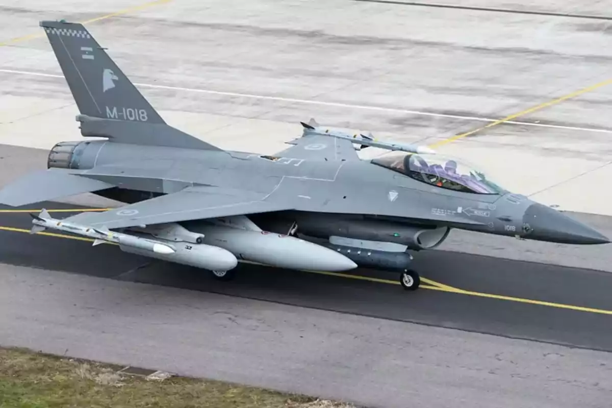 F-16 military fighter jet on a runway ready for takeoff F-16 military fighter jet on a runway ready for takeoff