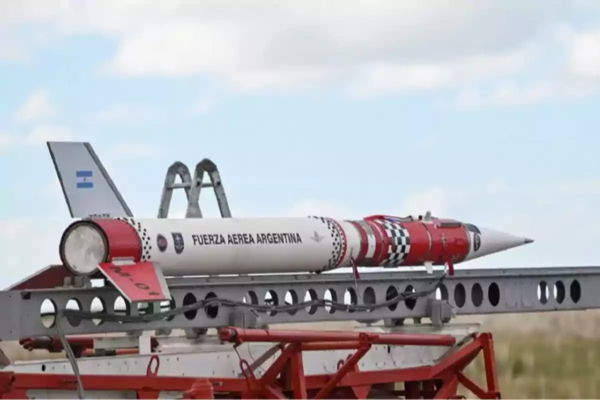 Un cohete de la Fuerza Aérea Argentina en una plataforma de lanzamiento con un diseño rojo y blanco.