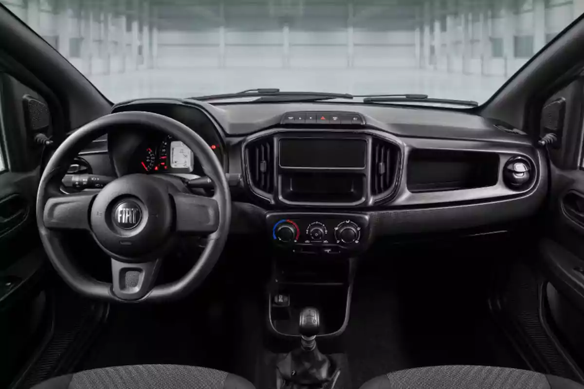 Interior of a Fiat car with steering wheel, instrument panel, air conditioning controls, and gear shift in the foreground Interior of a Fiat car with steering wheel, instrument panel, air conditioning controls, and gear shift in the foreground