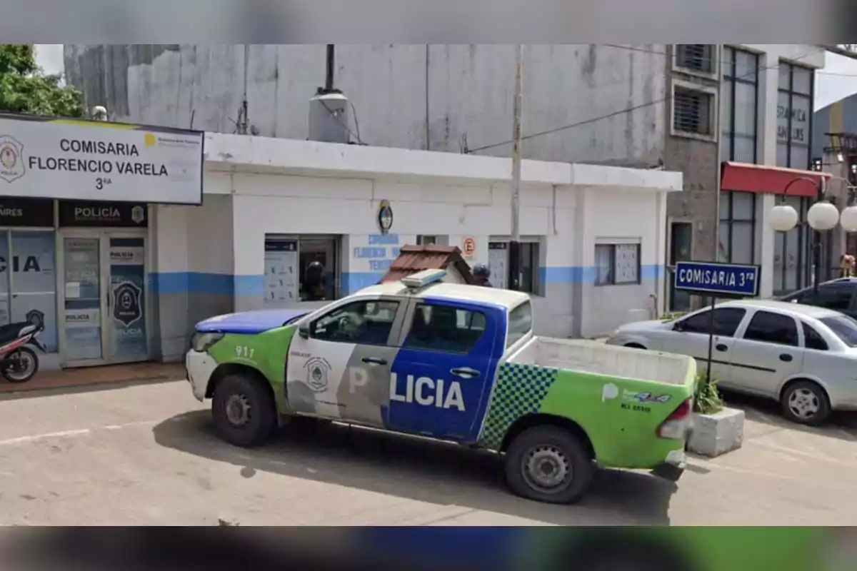 A police van is parked in front of a police station in an urban setting.