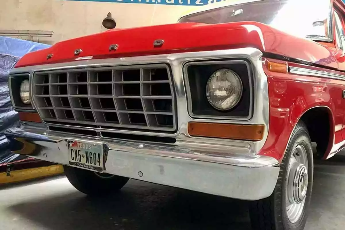 A classic red truck with a prominent front grille and a Texas license plate. A classic red truck with a prominent front grille and a Texas license plate.