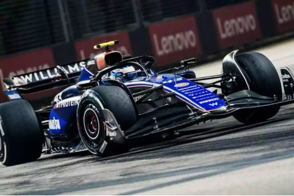 A blue and black race car moving on a racetrack. A blue and black race car moving on a racetrack.