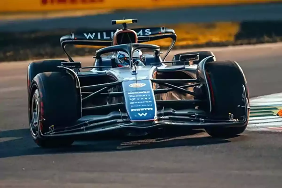 A Williams Formula 1 car taking a corner on the track. A Williams Formula 1 car taking a corner on the track.