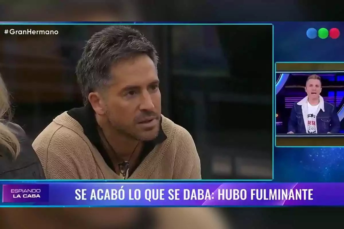A man with a serious expression appears on the screen of a TV show called A man with a serious expression appears on the screen of a TV show called