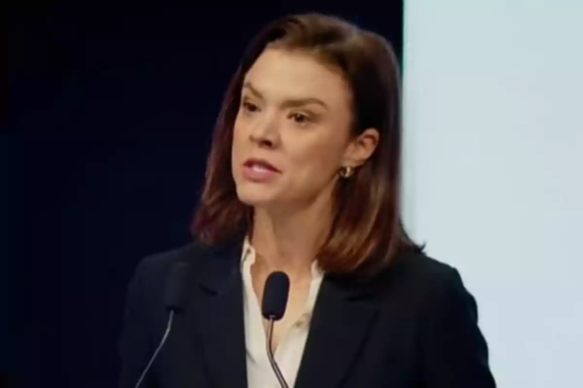 A woman speaking at a podium with microphones. A woman speaking at a podium with microphones.