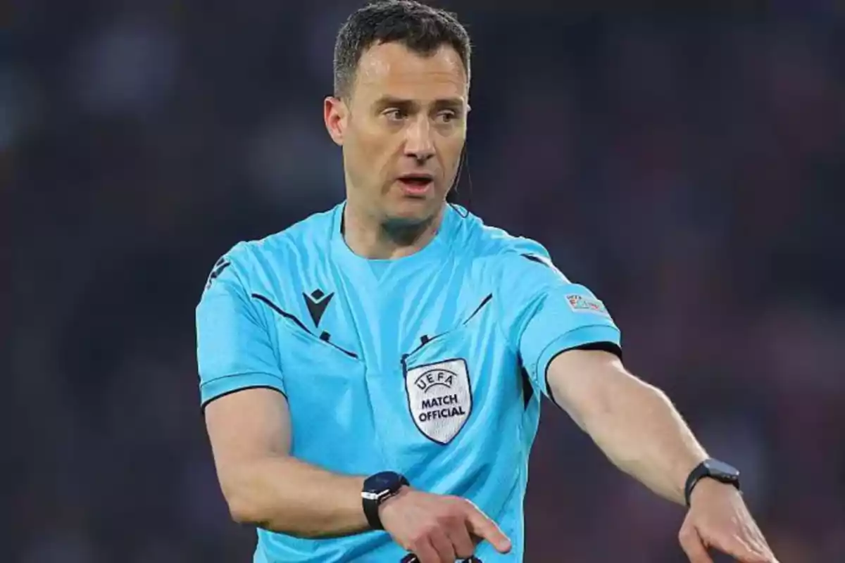 Soccer referee in a blue uniform signaling during a match Soccer referee in a blue uniform signaling during a match