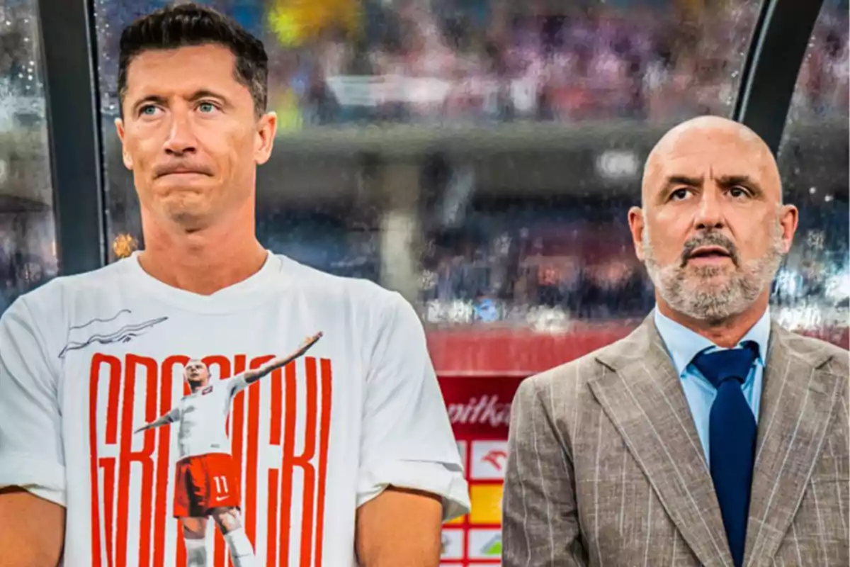 Two men standing in a stadium, one wearing a white t-jersey with a graphic design and the other in a suit and blue tie