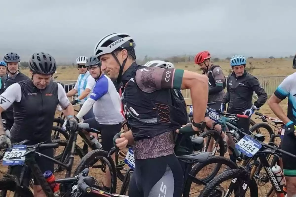 Cyclists getting ready for a mountain race on a cloudy day.
