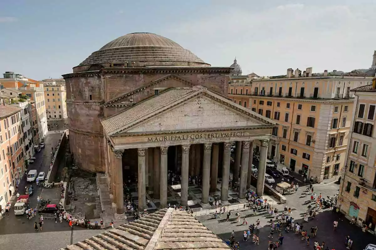 Aerial view of the Pantheon in Rome surrounded by buildings and with tourists in the front plaza. Aerial view of the Pantheon in Rome surrounded by buildings and with tourists in the front plaza.