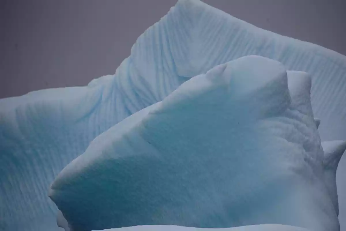 Textured blue ice formations in a cold, cloudy environment Textured blue ice formations in a cold, cloudy environment