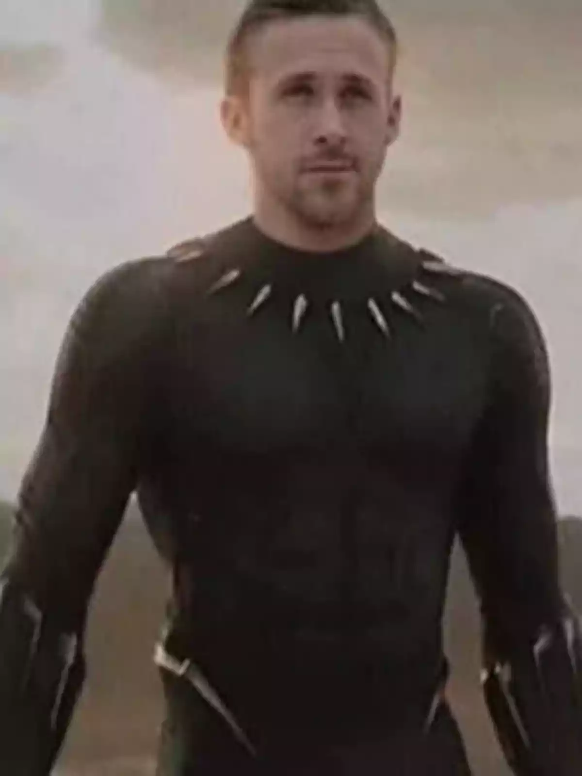 Blond man with a short beard wearing a black suit similar to Black Panther's in an outdoor setting