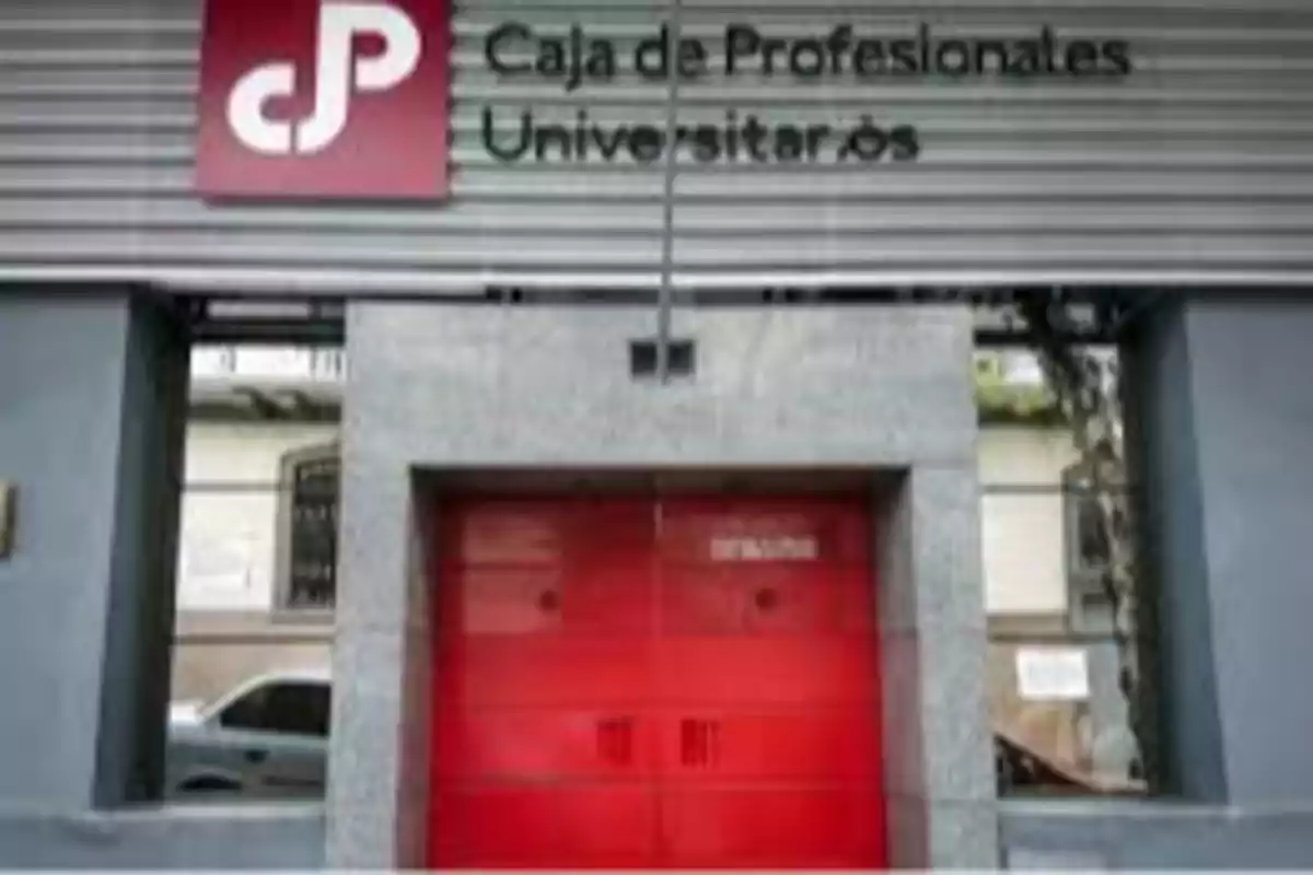 Facade of the Caja de Profesionales Universitarios with a red door and a sign at the top