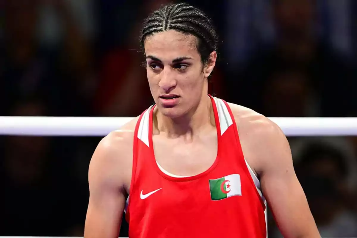 Boxer wearing a red jersey and the Algerian flag in the ring Boxer wearing a red jersey and the Algerian flag in the ring