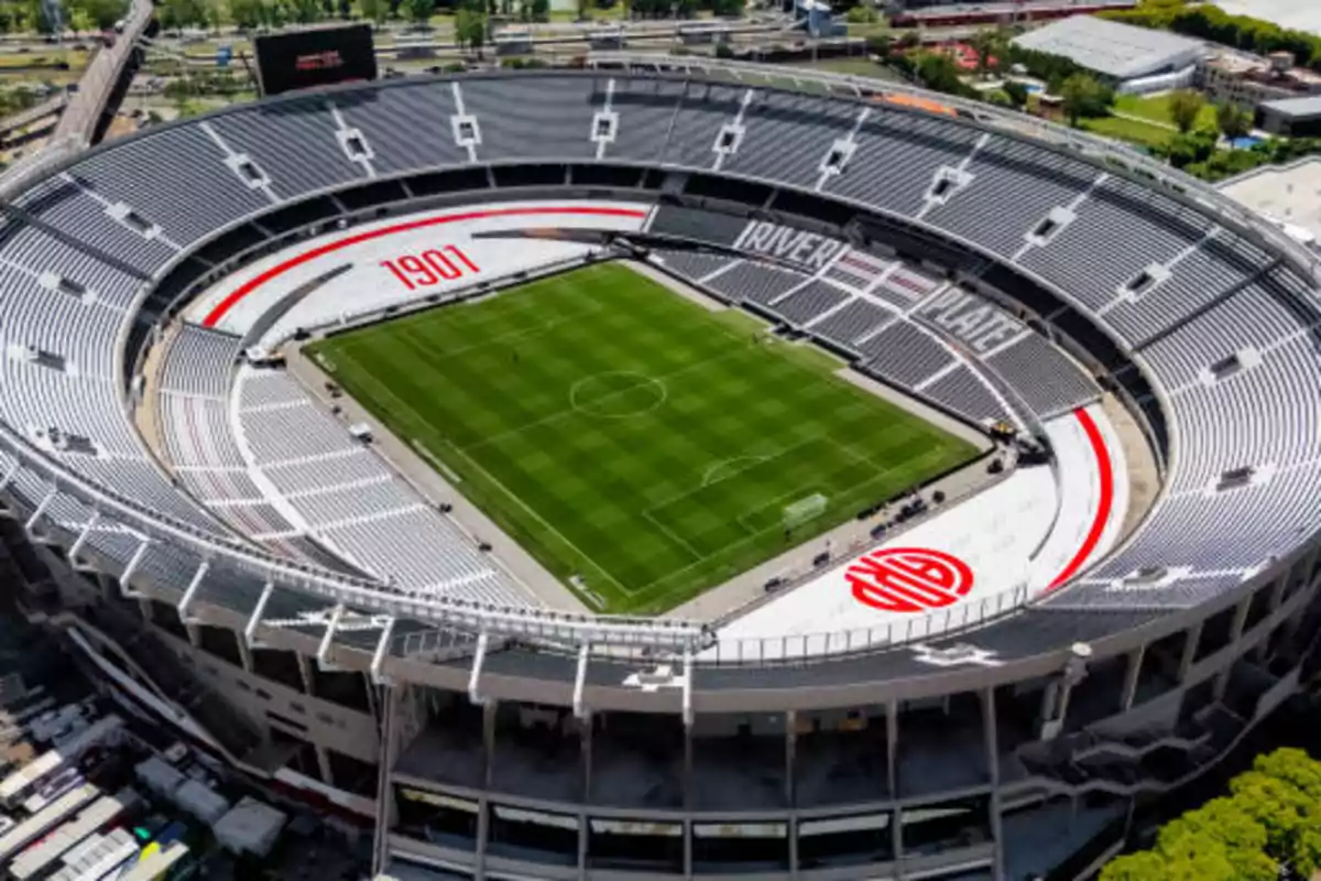 Aerial view of a soccer stadium with empty stands and well-maintained grass.