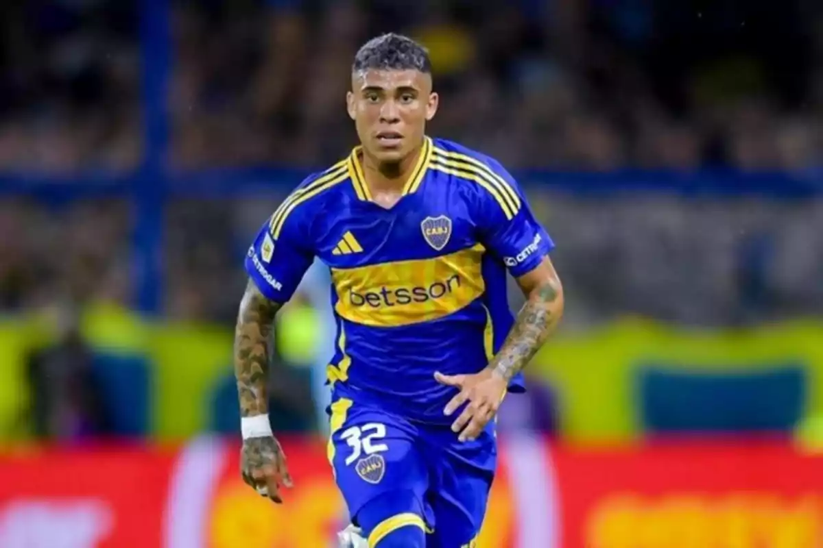 Soccer player in a blue and yellow Boca Juniors uniform running on the field during a match Soccer player in a blue and yellow Boca Juniors uniform running on the field during a match