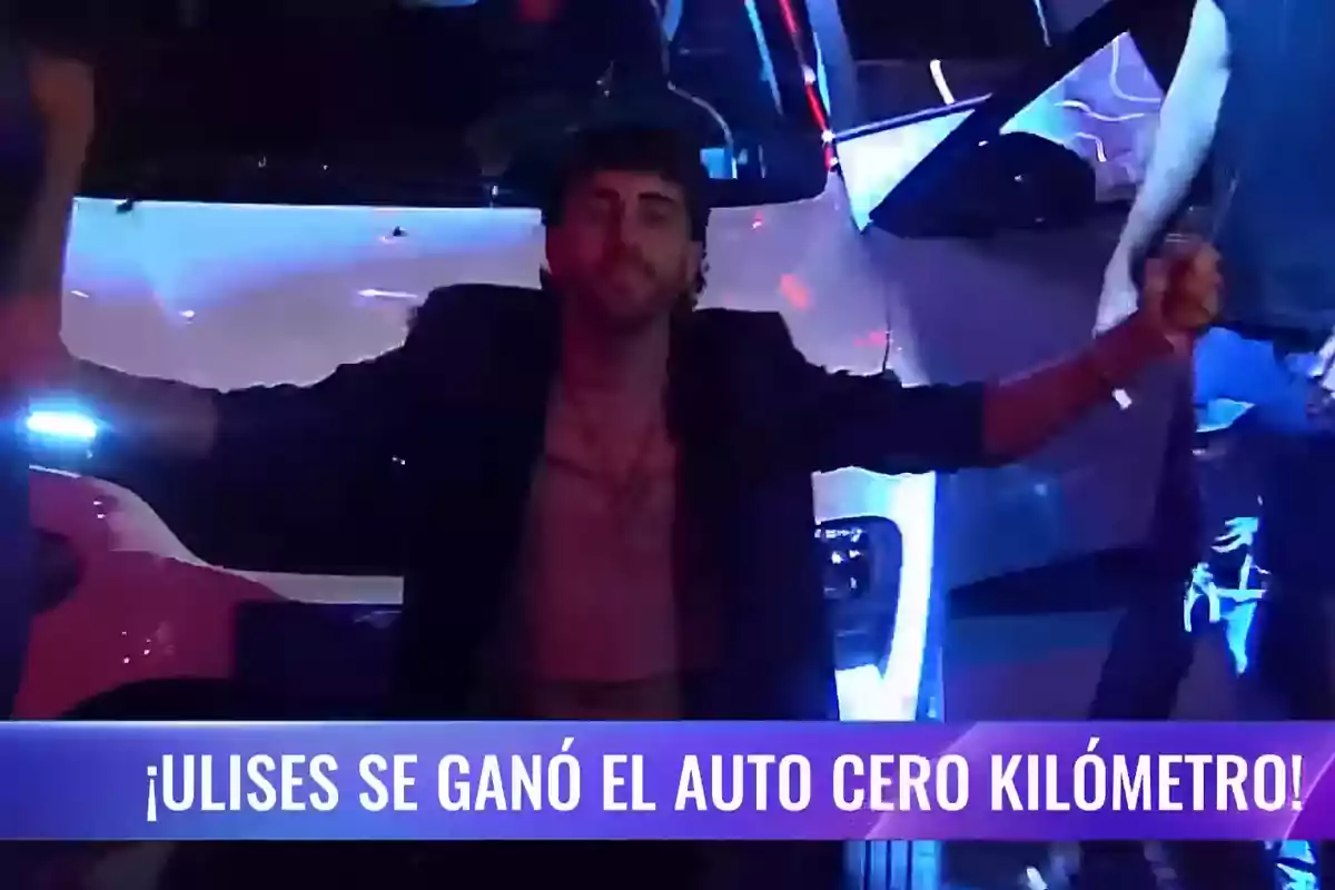 A man celebrating in front of a white car with colored lights around and a text that says he won a brand new car.