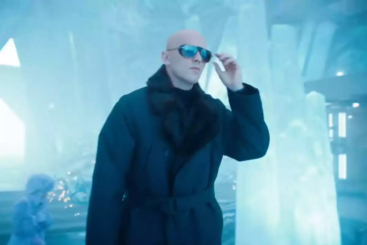 A bald man with sunglasses and a dark coat walks in an icy environment. A bald man with sunglasses and a dark coat walks in an icy environment.