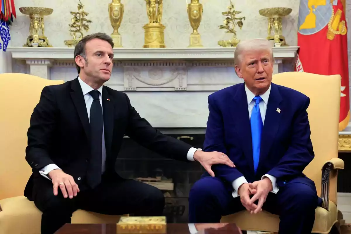Two men sitting in an elegant room with golden decorations, one of them with his hand on the other's arm. Two men sitting in an elegant room with golden decorations, one of them with his hand on the other's arm.