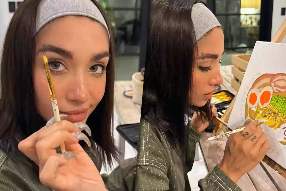 A person with a gray headband is painting a picture with bright colors while holding a brush and showing a focused expression.