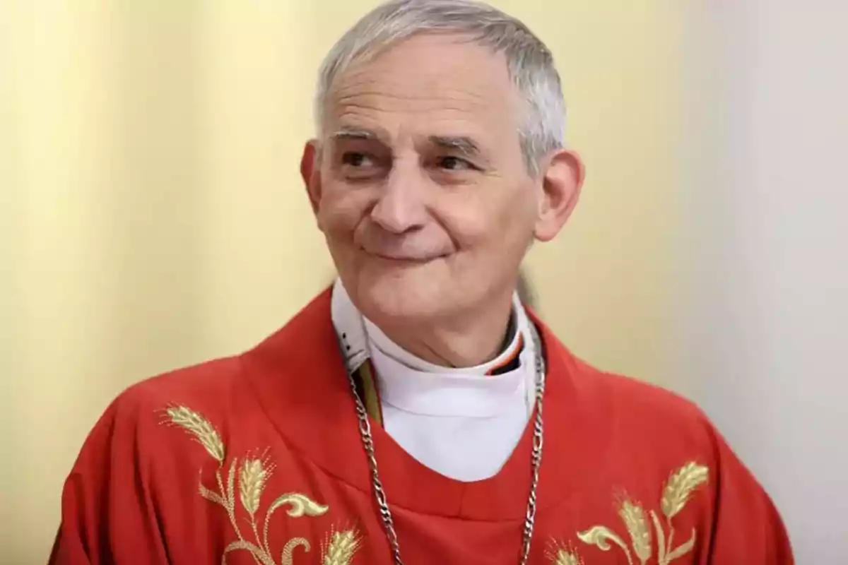 An elderly man with gray hair and red religious attire decorated with golden embroidery slightly smiles while looking to the side. An elderly man with gray hair and red religious attire decorated with golden embroidery slightly smiles while looking to the side.