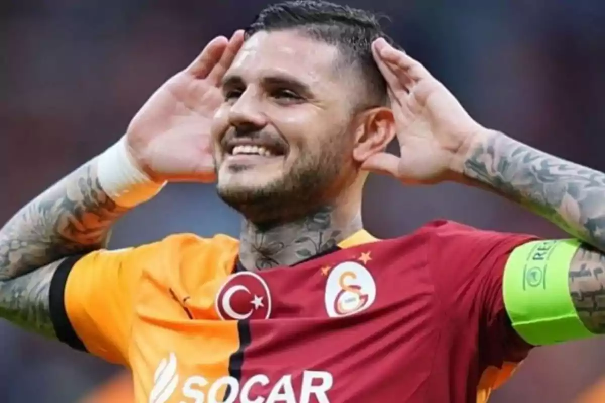 A player in a red and yellow uniform celebrates with his hands on his ears and a smile on his face. A player in a red and yellow uniform celebrates with his hands on his ears and a smile on his face.