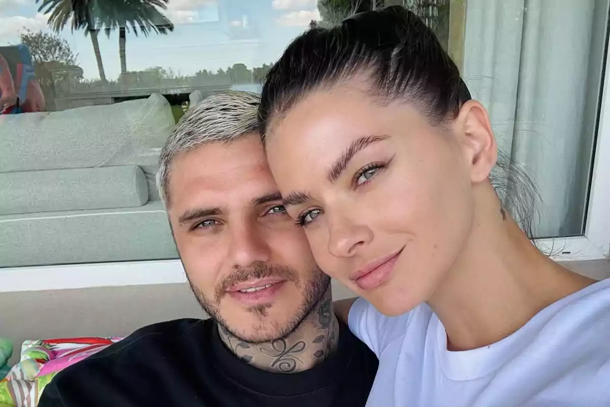 A smiling couple posing for an outdoor selfie.