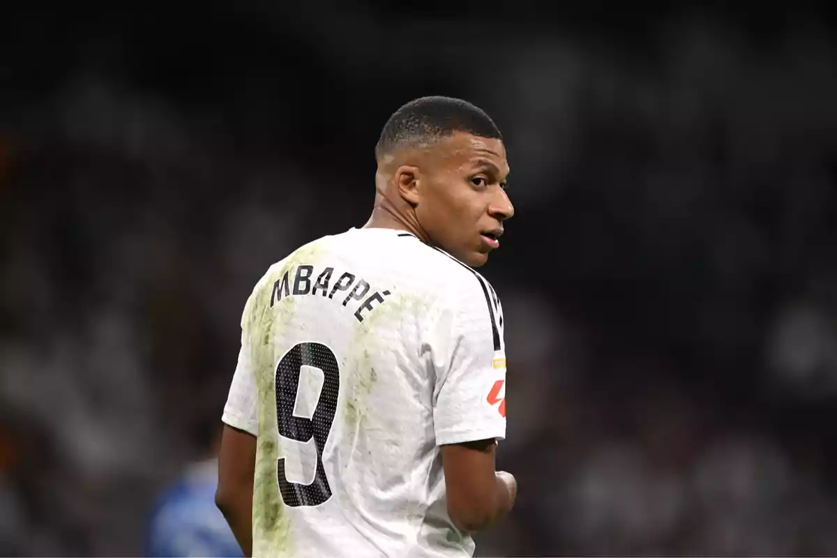 Soccer player wearing a white jersey with the number 9 on the back during a match Soccer player wearing a white jersey with the number 9 on the back during a match