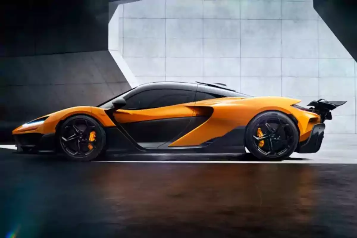 Orange sports car with black accents parked in a modern concrete setting