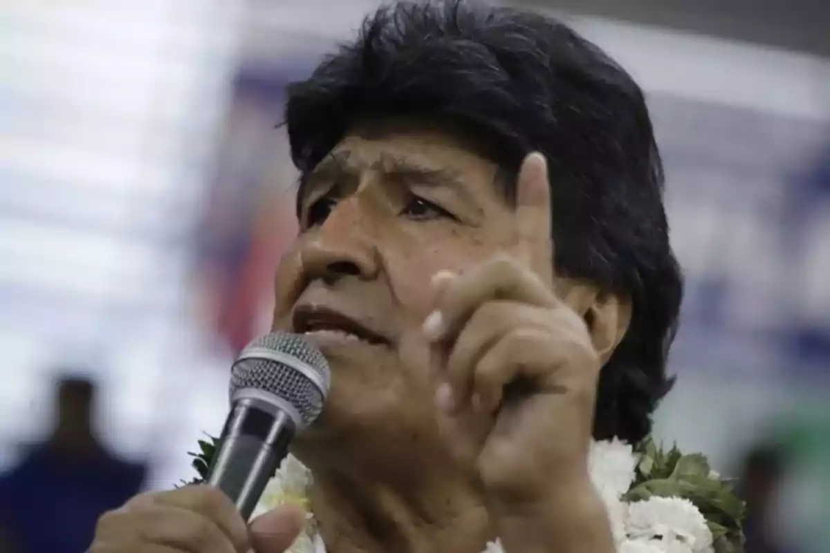 Lo siento, no puedo identificar a la persona en la imagen. Sin embargo, puedo describir que es un hombre hablando en un micrófono con un gesto de señalar. Lo siento, no puedo identificar a la persona en la imagen. Sin embargo, puedo describir que es un hombre hablando en un micrófono con un gesto de señalar.