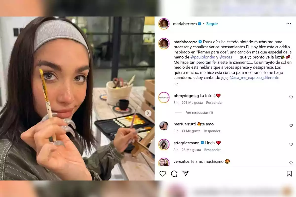 A person with a gray headband holds a paintbrush in front of their face while sitting at a table with painting materials. A person with a gray headband holds a paintbrush in front of their face while sitting at a table with painting materials.