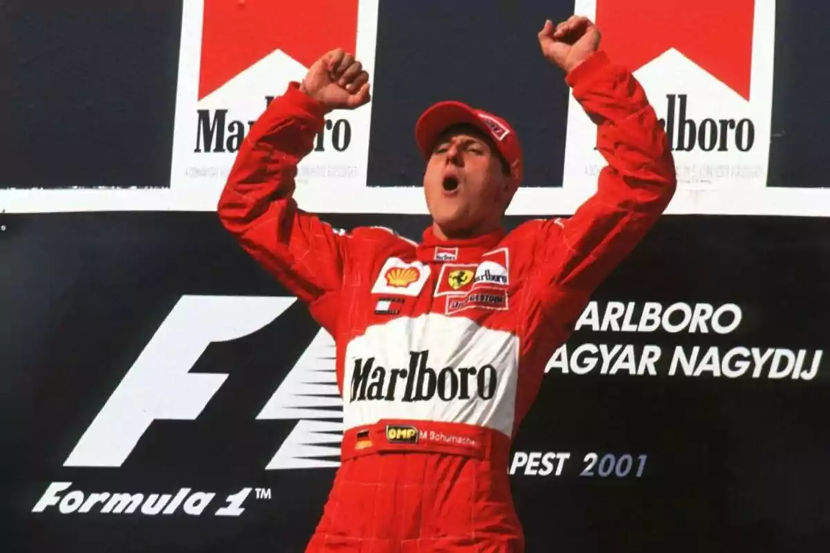 Formula 1 driver celebrating with arms raised on the podium after winning a race Formula 1 driver celebrating with arms raised on the podium after winning a race