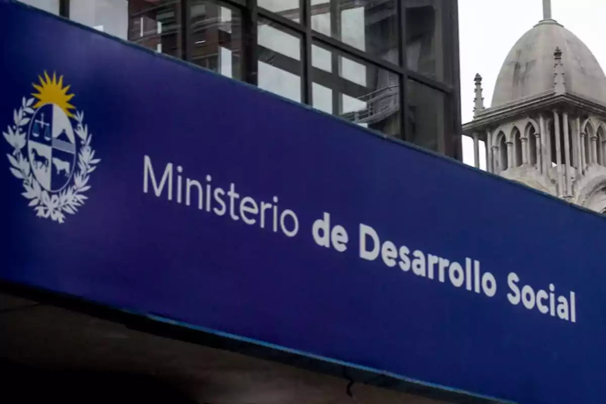 Blue sign of the Ministry of Social Development of Uruguay on the facade of a building
