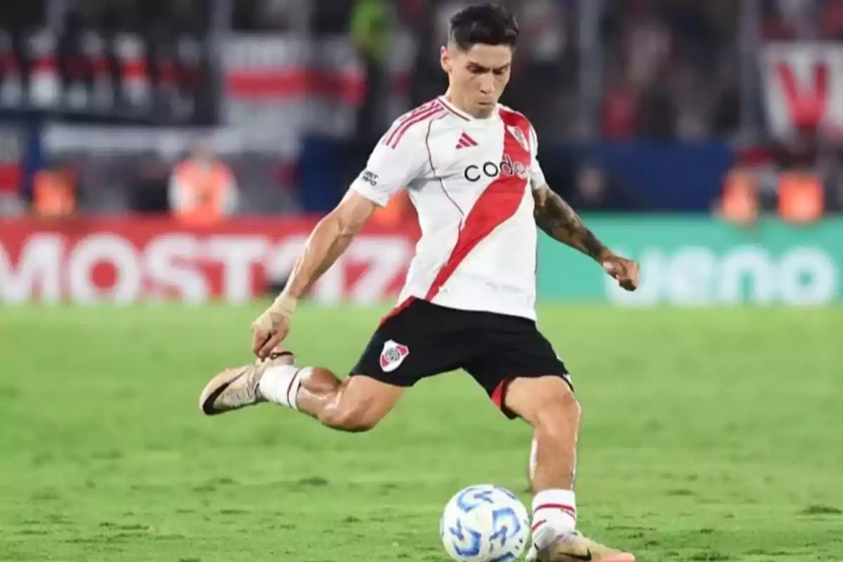 River Plate player kicking a ball on the field during a match. River Plate player kicking a ball on the field during a match.