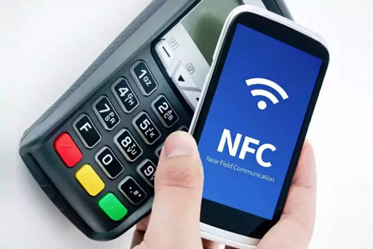 Person using a phone with NFC technology to make a payment at a point-of-sale terminal. Person using a phone with NFC technology to make a payment at a point-of-sale terminal.