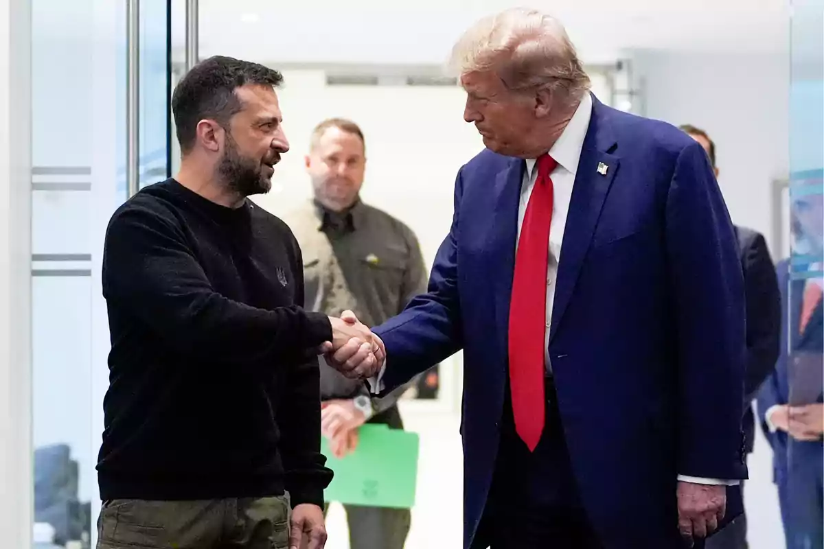 Two men shaking hands in a formal setting.