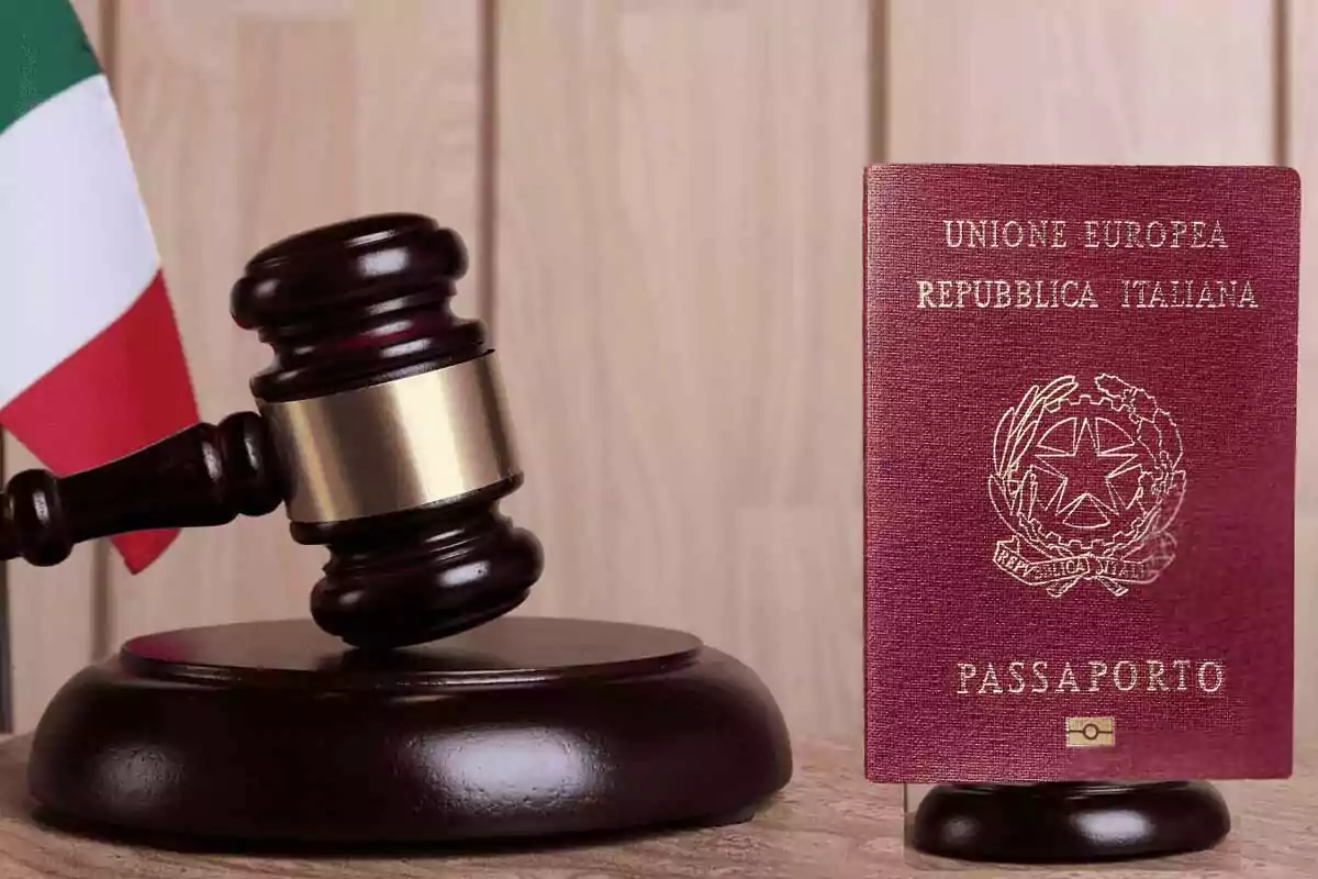An Italian passport next to a judge's gavel and an Italian flag in the background. An Italian passport next to a judge's gavel and an Italian flag in the background.