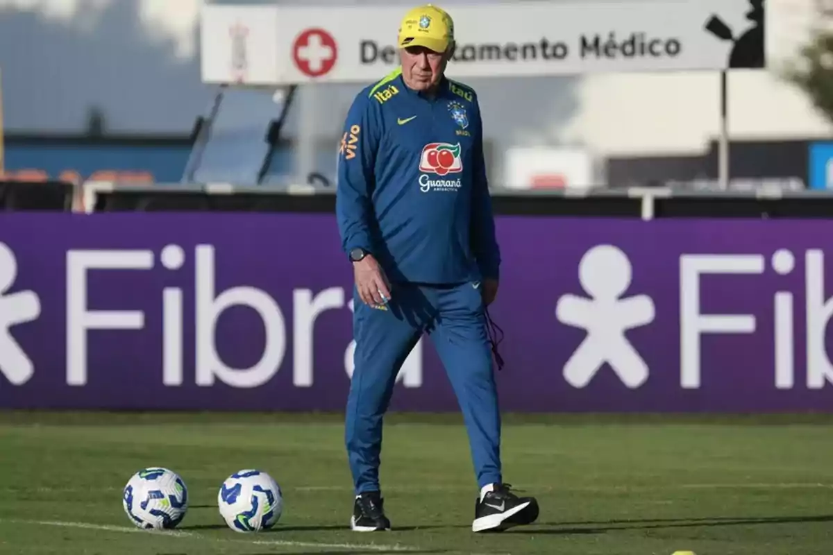 Coach of the Brazil national soccer team walking on the training field with two balls nearby Coach of the Brazil national soccer team walking on the training field with two balls nearby