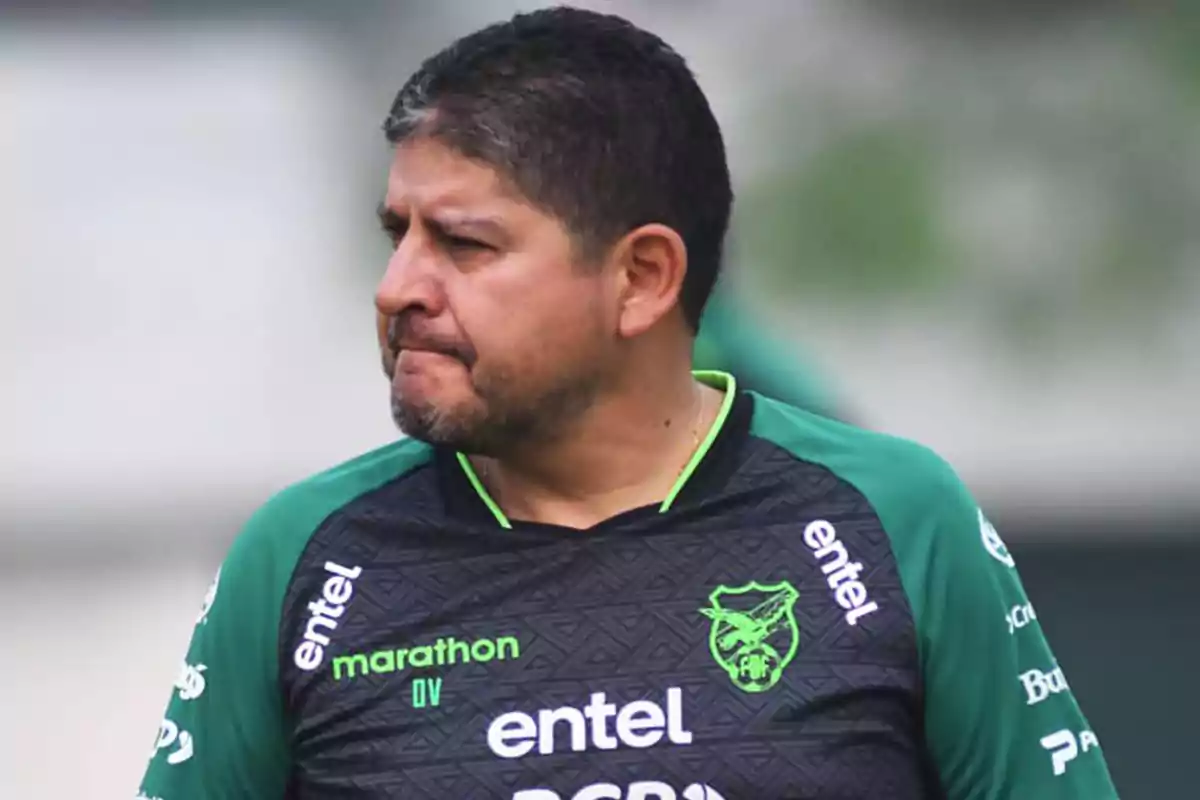 Man wearing a black and green Bolivia national soccer team jersey looking to the left Man wearing a black and green Bolivia national soccer team jersey looking to the left