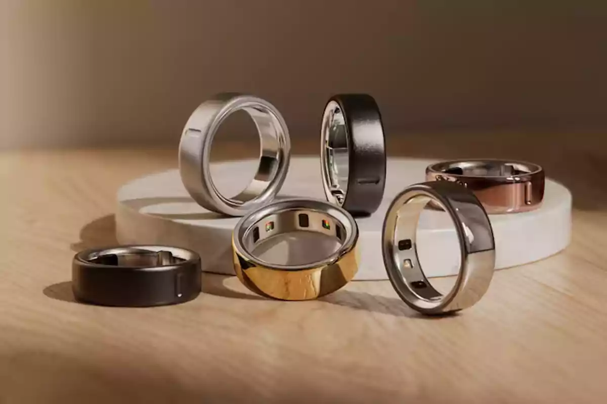 Smart rings of different colors and materials on a wood and marble surface. Smart rings of different colors and materials on a wood and marble surface.