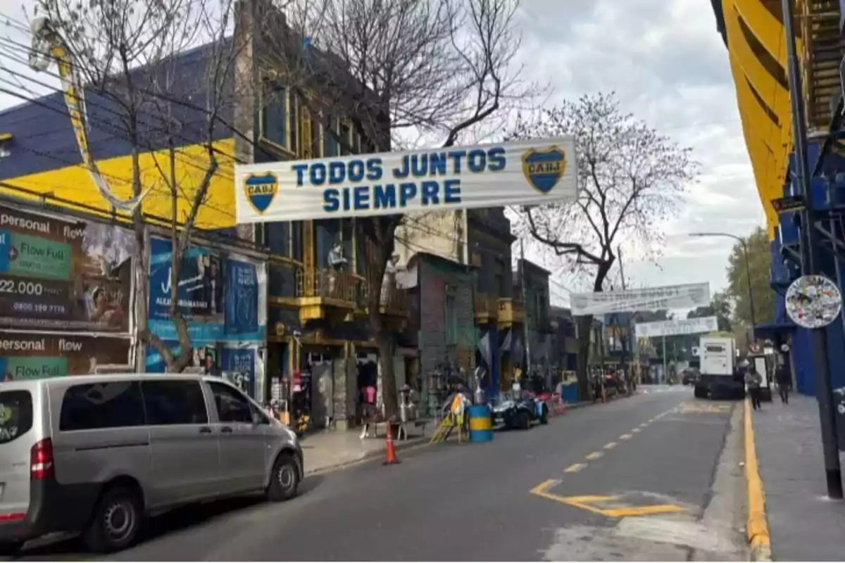 A street with buildings painted blue and yellow, a sign that says A street with buildings painted blue and yellow, a sign that says
