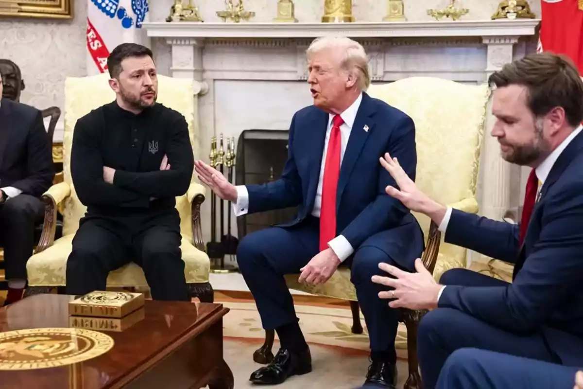 A group of people sitting in an elegant room, conversing seriously.