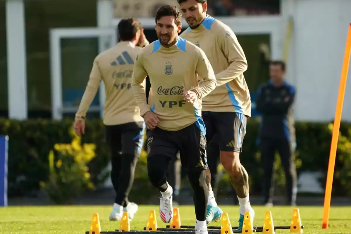 Argentine national team players training on the field with cones and an agility ladder