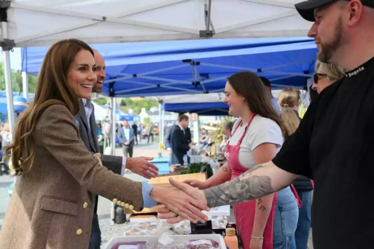 People shaking hands in an outdoor market under blue tents. People shaking hands in an outdoor market under blue tents.