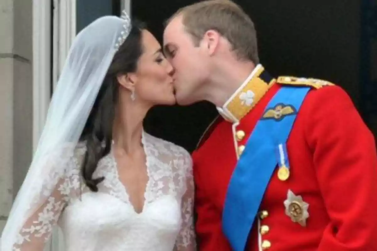 A couple dressed as bride and groom kisses on a balcony. A couple dressed as bride and groom kisses on a balcony.