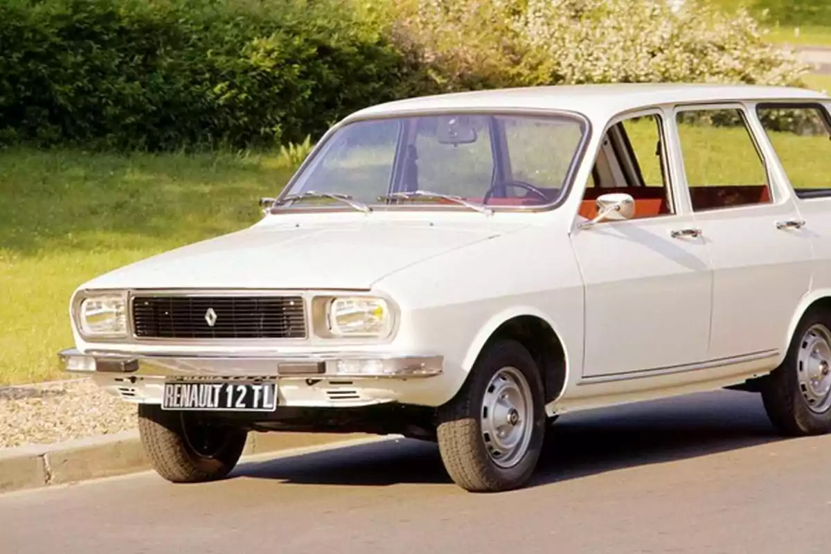 A white classic car parked on a street with greenery in the background. A white classic car parked on a street with greenery in the background.