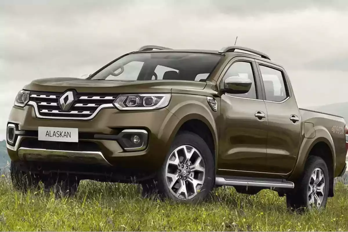 Camioneta Renault Alaskan color marrón estacionada en un campo con cielo nublado.