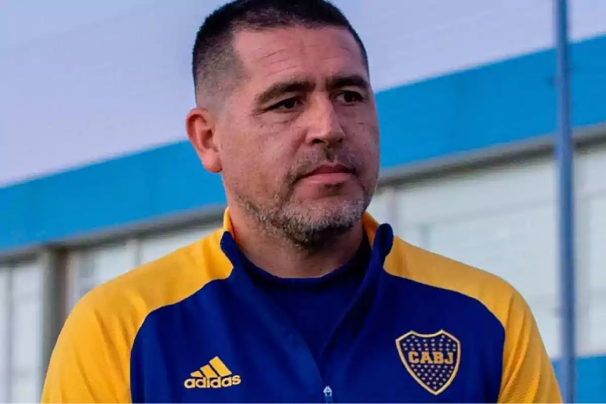 Man in a blue and yellow sports jacket with the CABJ logo in an urban setting. Man in a blue and yellow sports jacket with the CABJ logo in an urban setting.