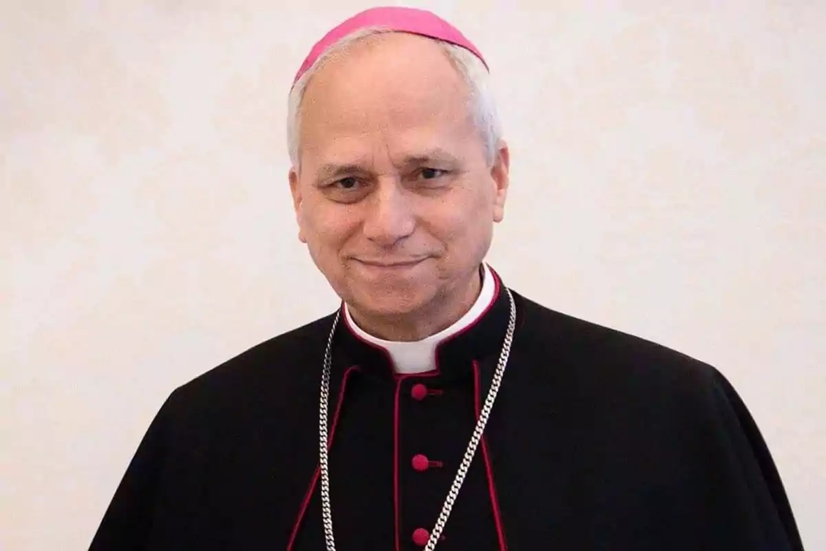 An elderly man in religious attire and a pink mitre. An elderly man in religious attire and a pink mitre.