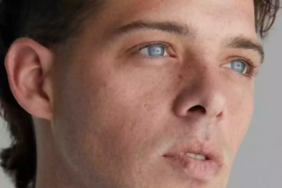 Close-up of a man with blue eyes looking into the distance.